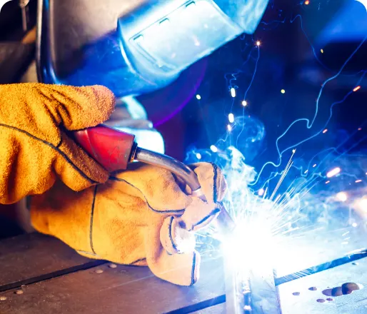 Operator welding a metal part